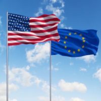 two flags of usa and European Union on a sky background